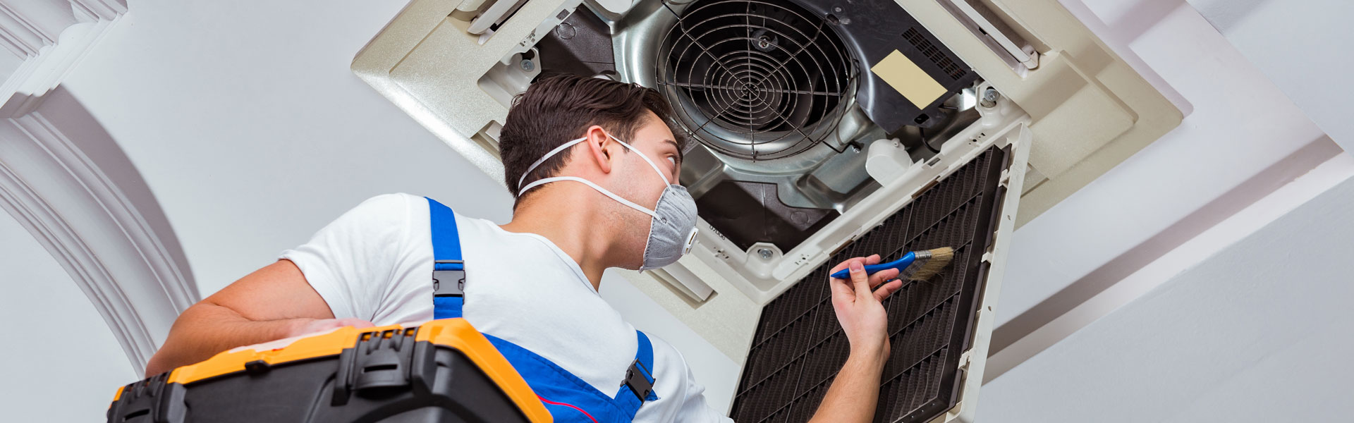 Worker Servicing Ceiling AC